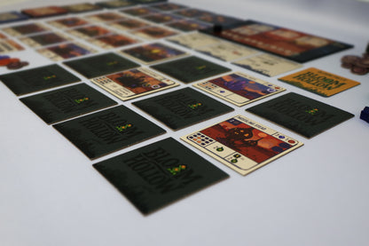 Collection of board game cards on a white surface