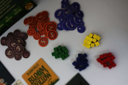 Tokens for 'Bloom Hollow' on a white surface